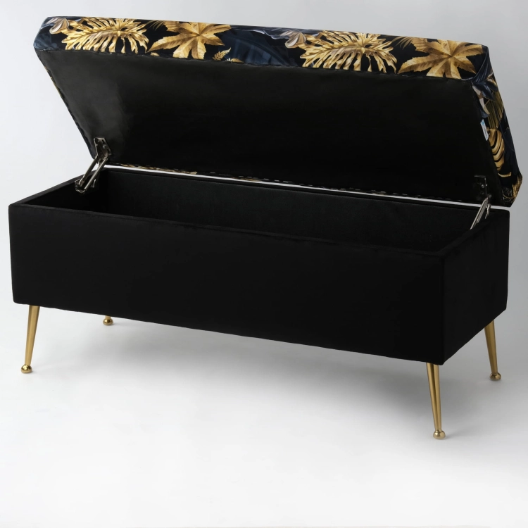 Élégant pouf de rangement noir avec revêtement en feuilles, sur pieds en métal doré