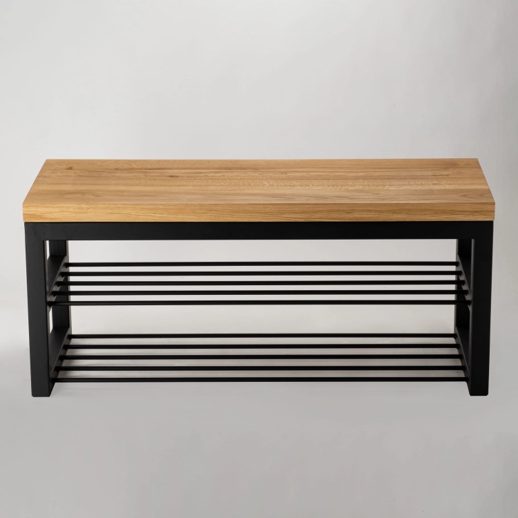 Un banc avec un plateau en bois et une base en acier dans un style loft.